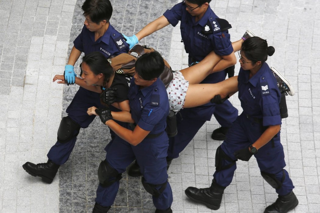 A protester was taken away by the police after storming into the government building..jpg