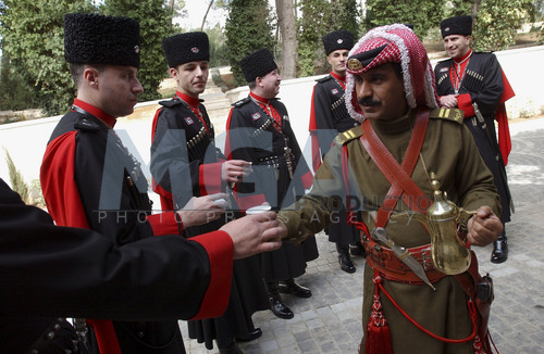 A soldier from the Bedouin Royal Guard serving coffee to Circassian soldiers.jpg