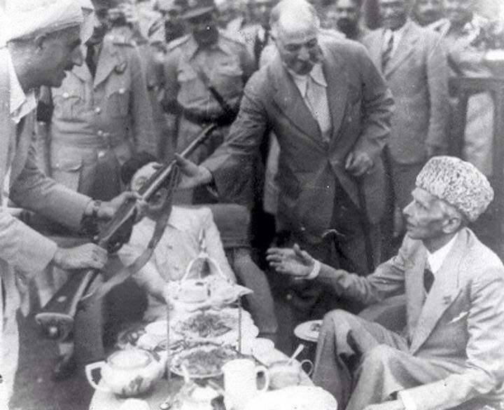 Leader of Mehsud tribe presenting his rifle to Jinnah as a tribute of honor.jpg