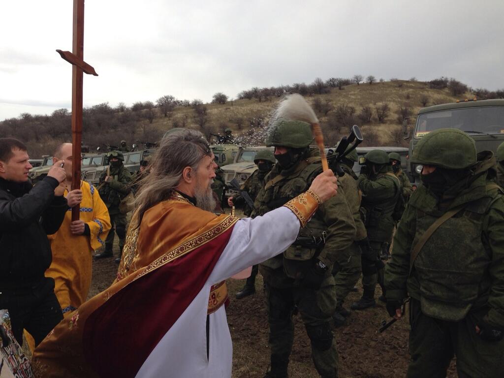 Orthodox priest blessing #Russian troops surrounding #Ukraine military base in #Crimea.jpg