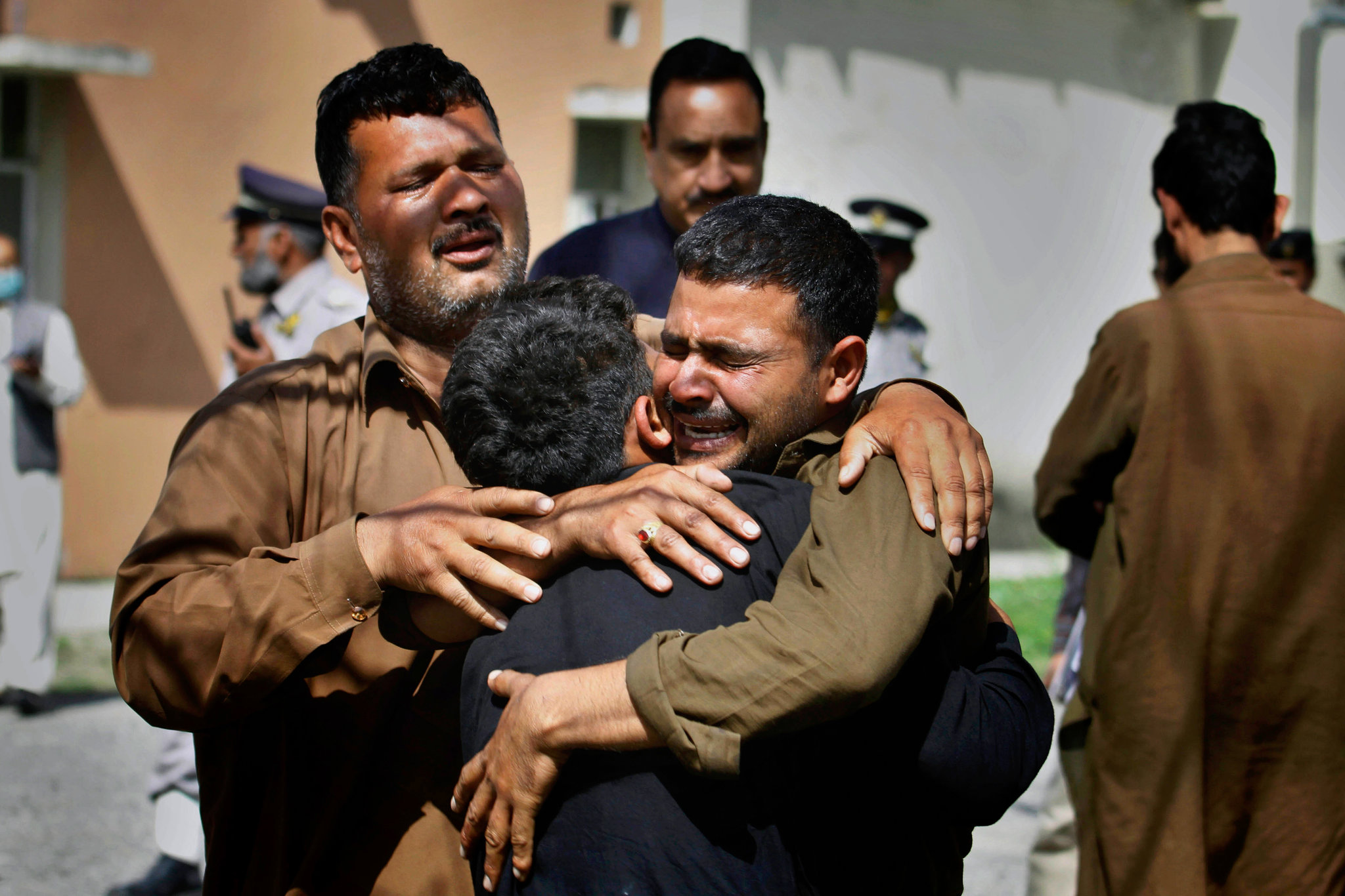 People mourned the death of a relative after a bombing at a market on Wednesday in Islamabad.jpg