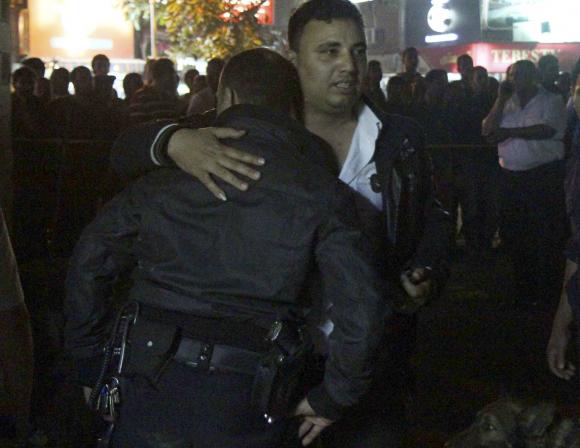 Police react as the body of a fellow police officer.jpg