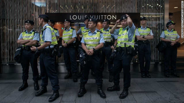 Policemen stood guard in front of a store in the Central district.jpg