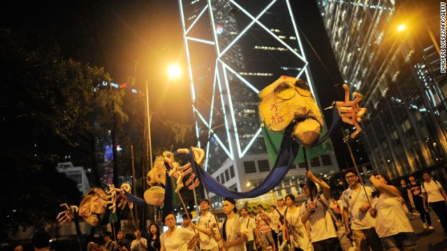 Protesters hold props as they marched on a street.jpg