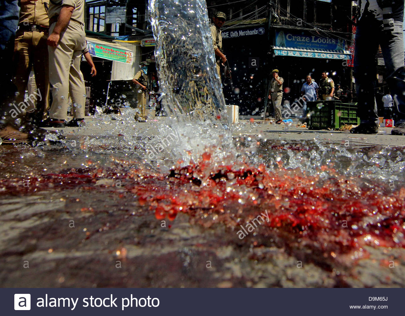 srinagar-indian-kashmir-june-22-2013-locals-washing-the-blood-stainmed-D9M65J.jpg