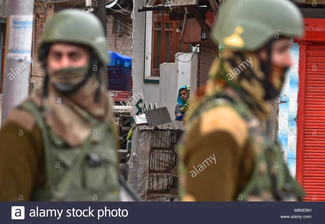 srinagar-kashmir-5th-mar-2018-a-kashmiri-woman-looks-on-as-kashmir-M6ND8H.jpg