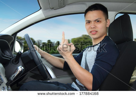 stock-photo-an-angry-driver-showing-the-middle-finger-177884168.jpg