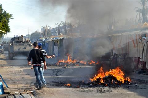 Sunni Muslim protesters set fire, blocking a road in the northern city of Tripoli.jpg