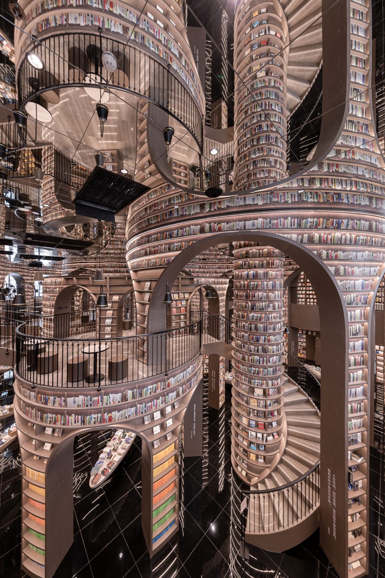 tall-bookshelf-arcs-mesmerizing-bookstore-xliving-china-designboom-full-width-02-scaled (1).jpg