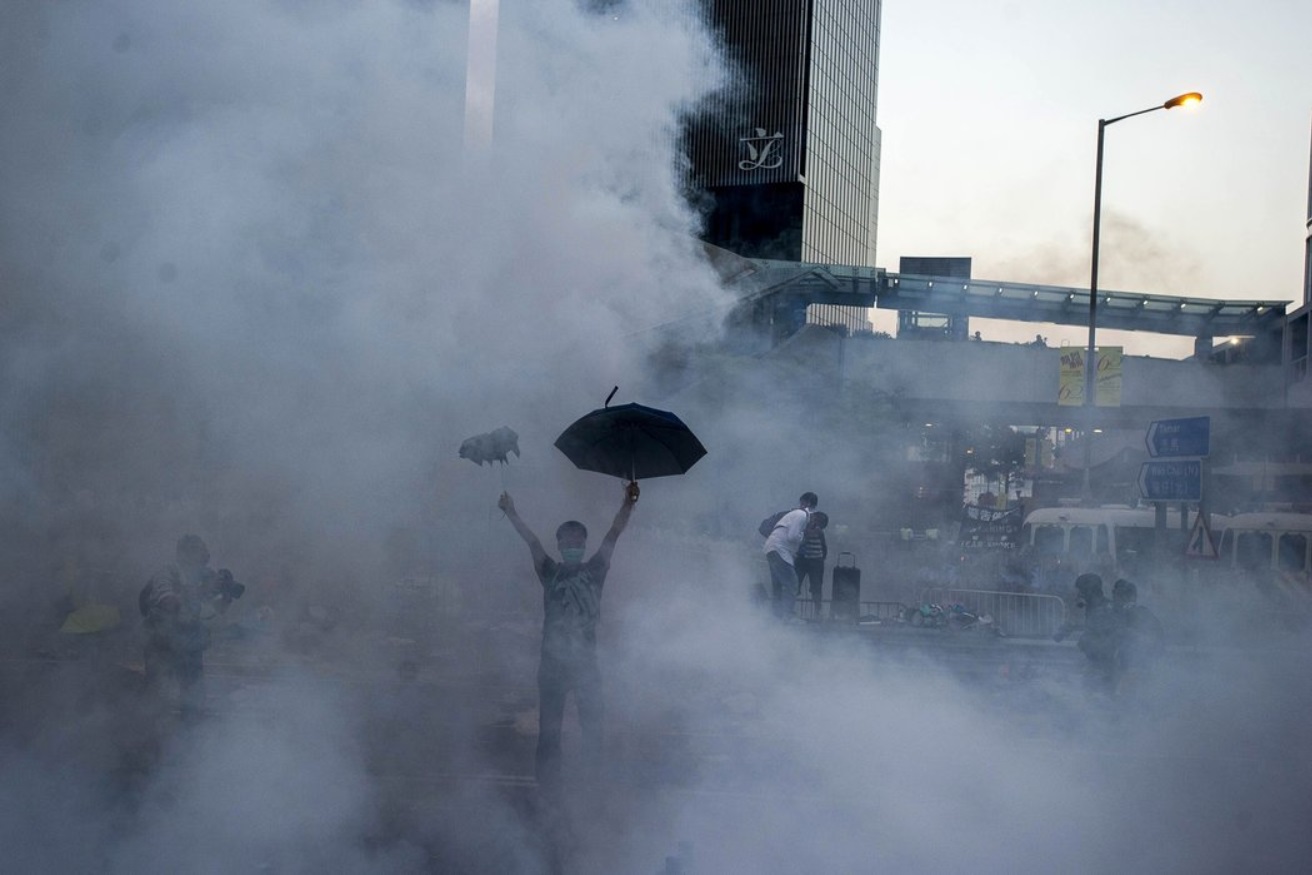 Thousands of residents with umbrellas and face masks defied police orders to clear the area..jpg