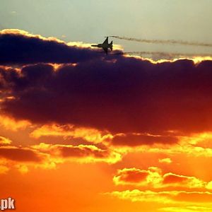 A smoking JF-17 on golden sky.