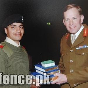 Queen Elizabeth of Britain awarding â€œSword of Honourâ€￾ to Pakistani Officer