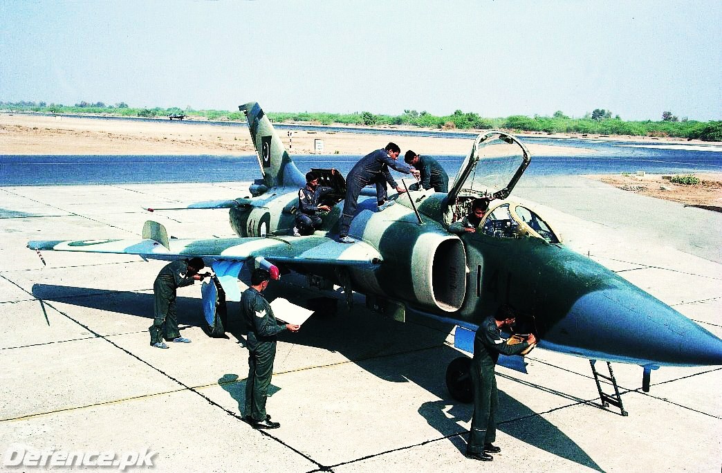 Ground crew busy working on an A-5 before a sortie