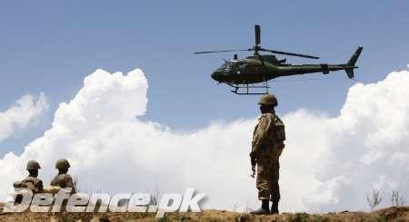 Pakistani heli flies near the Banie Baba Ziarat mountain