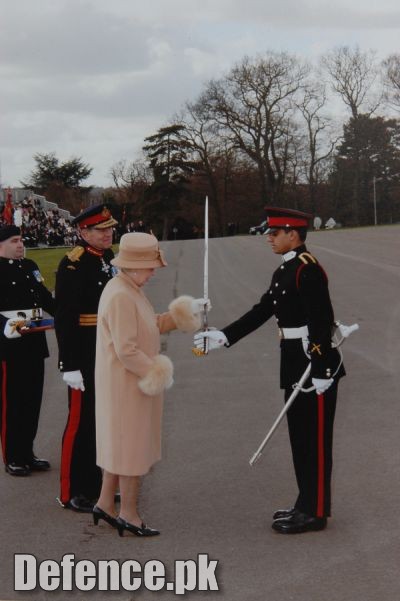 Queen Elizabeth of Britain awarding â€œSword of Honourâ€￾ to Pakistani Officer