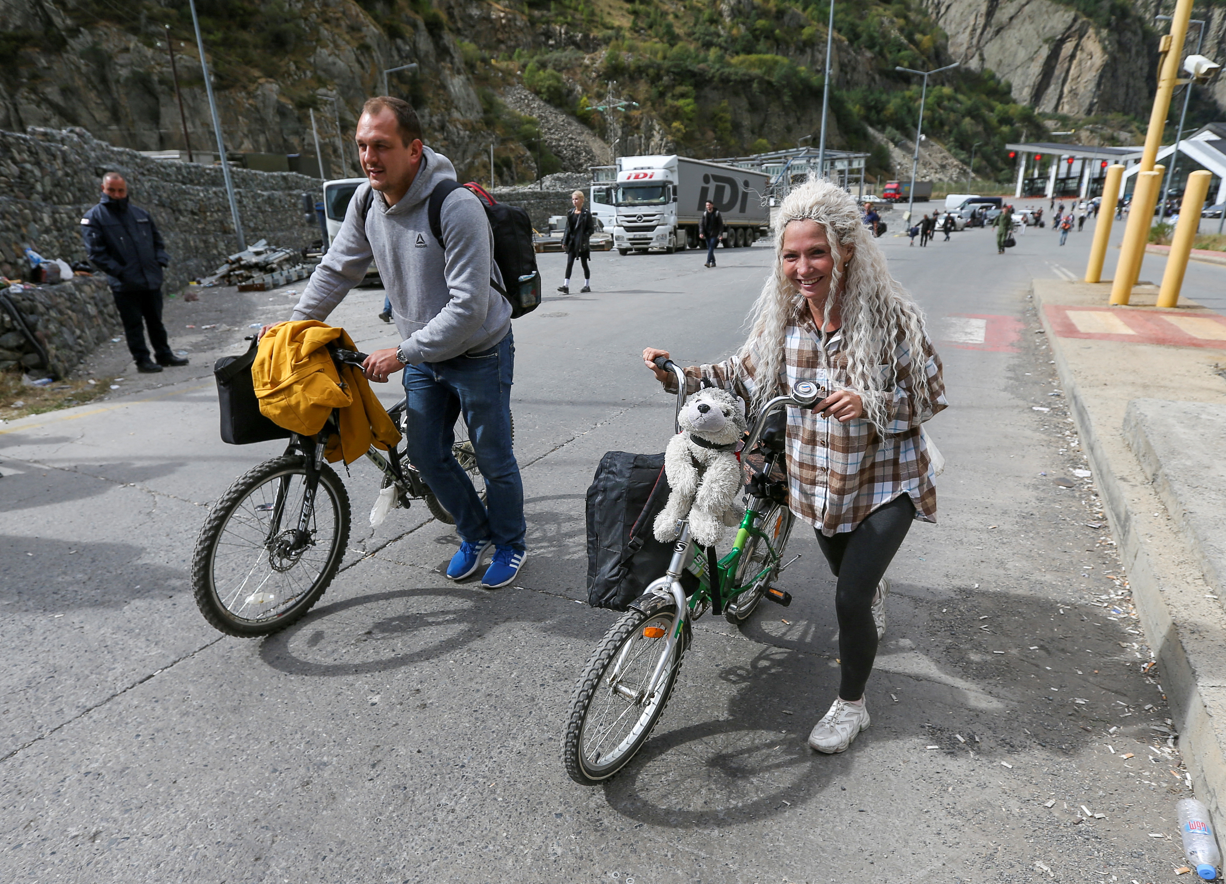 People cross border at Zemo Larsi checkpoint while leaving Russia