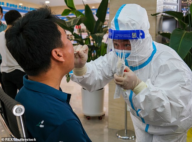 Some residents have claimed that they didn't know a lockdown was happening until after authorities shut down Xiong'an. Picutred; Medical staff take nucleic acid sample for a person in Xiong'an New Area in Baoding city