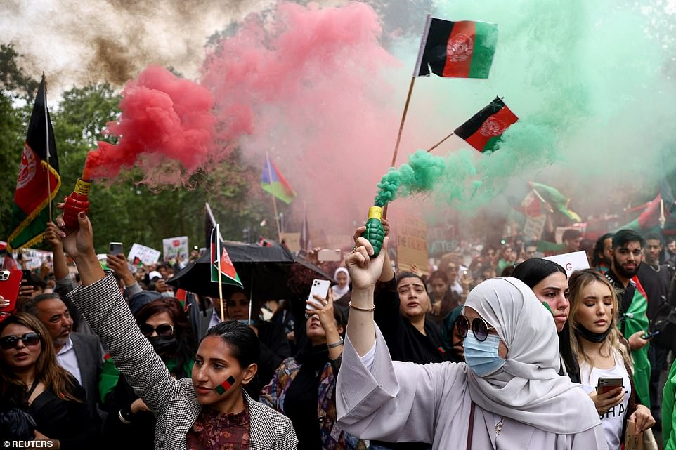 Men and women let off green and red flares in the street, waved the country's flag and held up huge banners during the protest's flag and held up huge banners during the protest