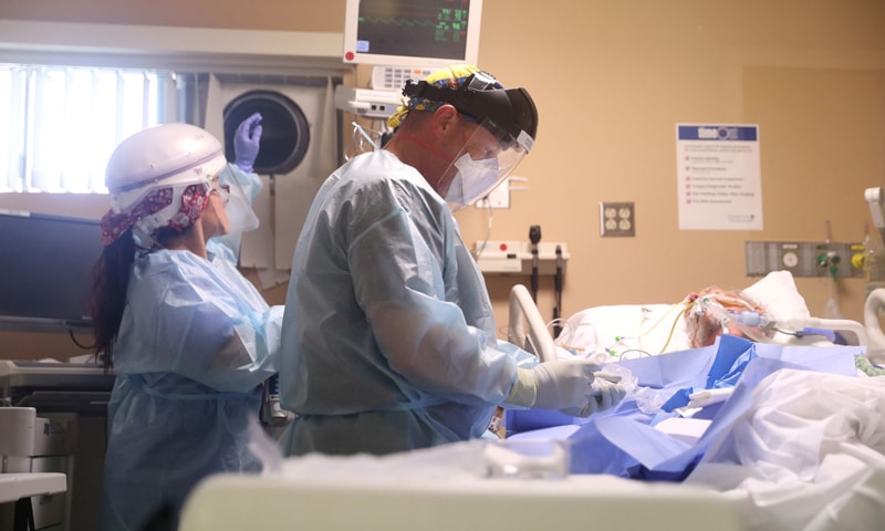 In this file photo, Pulmonary and critical care physician Dr Robert Goldberg, 44, puts an arterial line for blood pressure monitoring in a Covid-19 patient in the ICU at Providence Mission Hospital in Mission Viejo, California, US. — Reuters/File