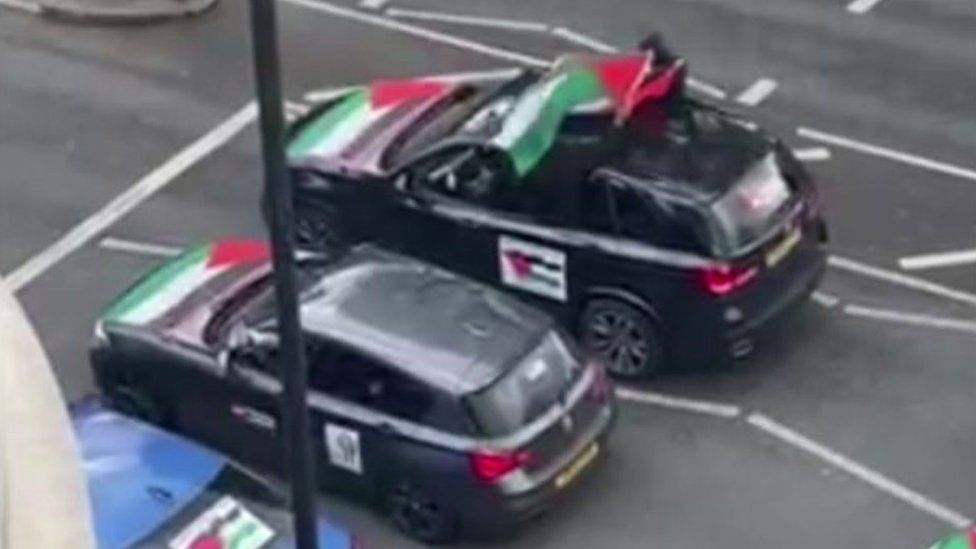 A grab from the video filmed and shared on social media, it shows two cars parked at traffic lights with Palestinian flags