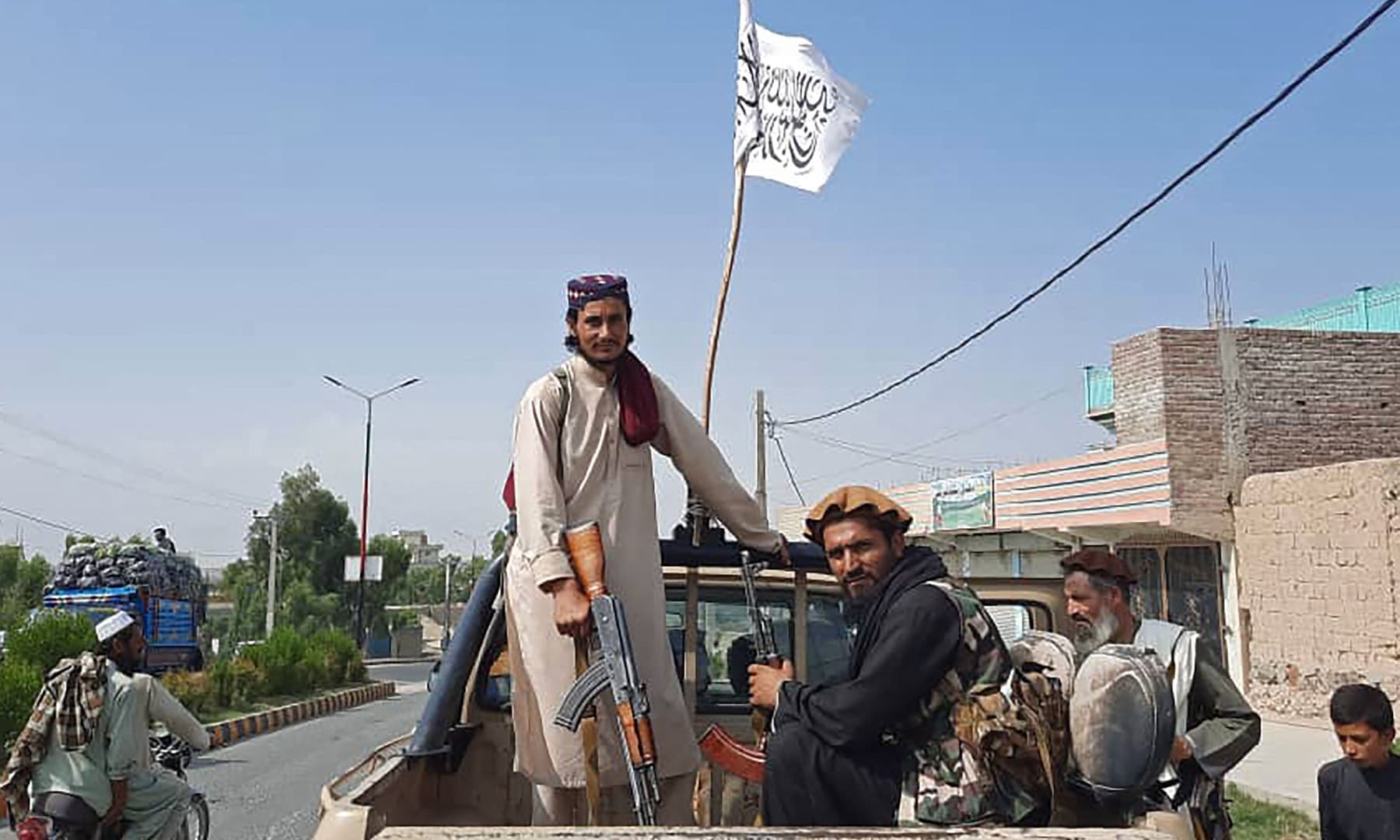 Taliban fighters drive an Afghan National Army vehicle through the streets of Laghman province, Afghanistan on August 15, 2021. — AFP