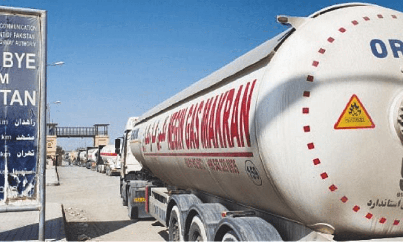 <p>TAFTAN: Trucks and gas tankers wait at Pakistan Gate to enter Iran.—Photo by Ali Raza Rind/File</p>