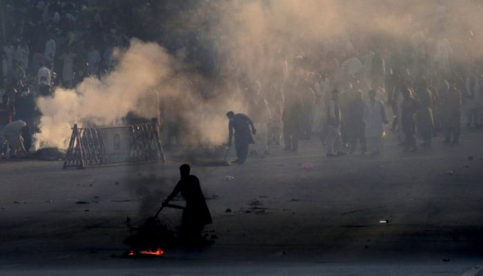 Police use teargas to disperse protestors of Pakistan Tehreek-e-Insaf (PTI) during a demonstration against the decision to disqualify former prime minister Imran Khan from running for political office, in Islamabad on October 21, 2022. — AFP