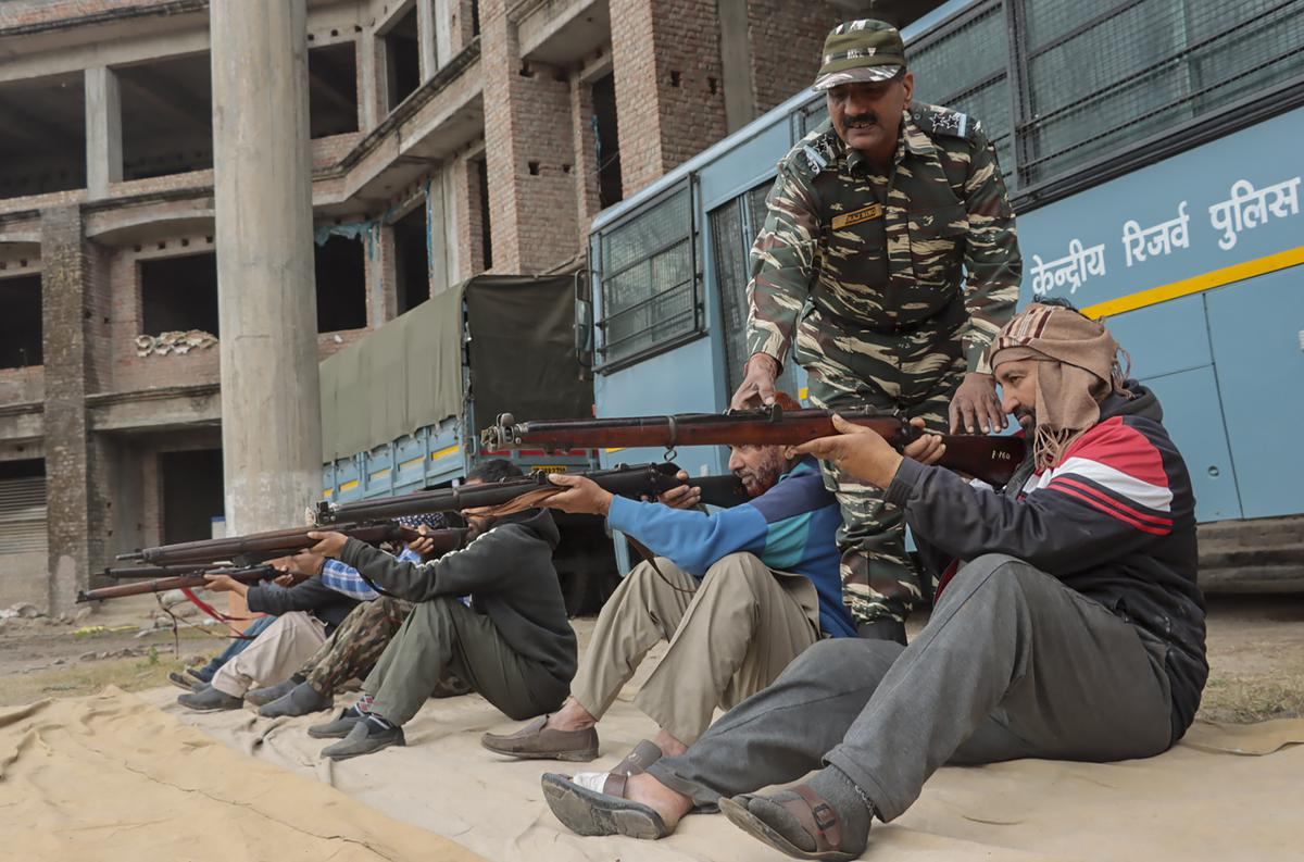 A CRPF jawan trains village defence guards near the line of control (LoC) in Mendhar area of Jammu and Kashmir’s Poonch district on January 14, 2023. 