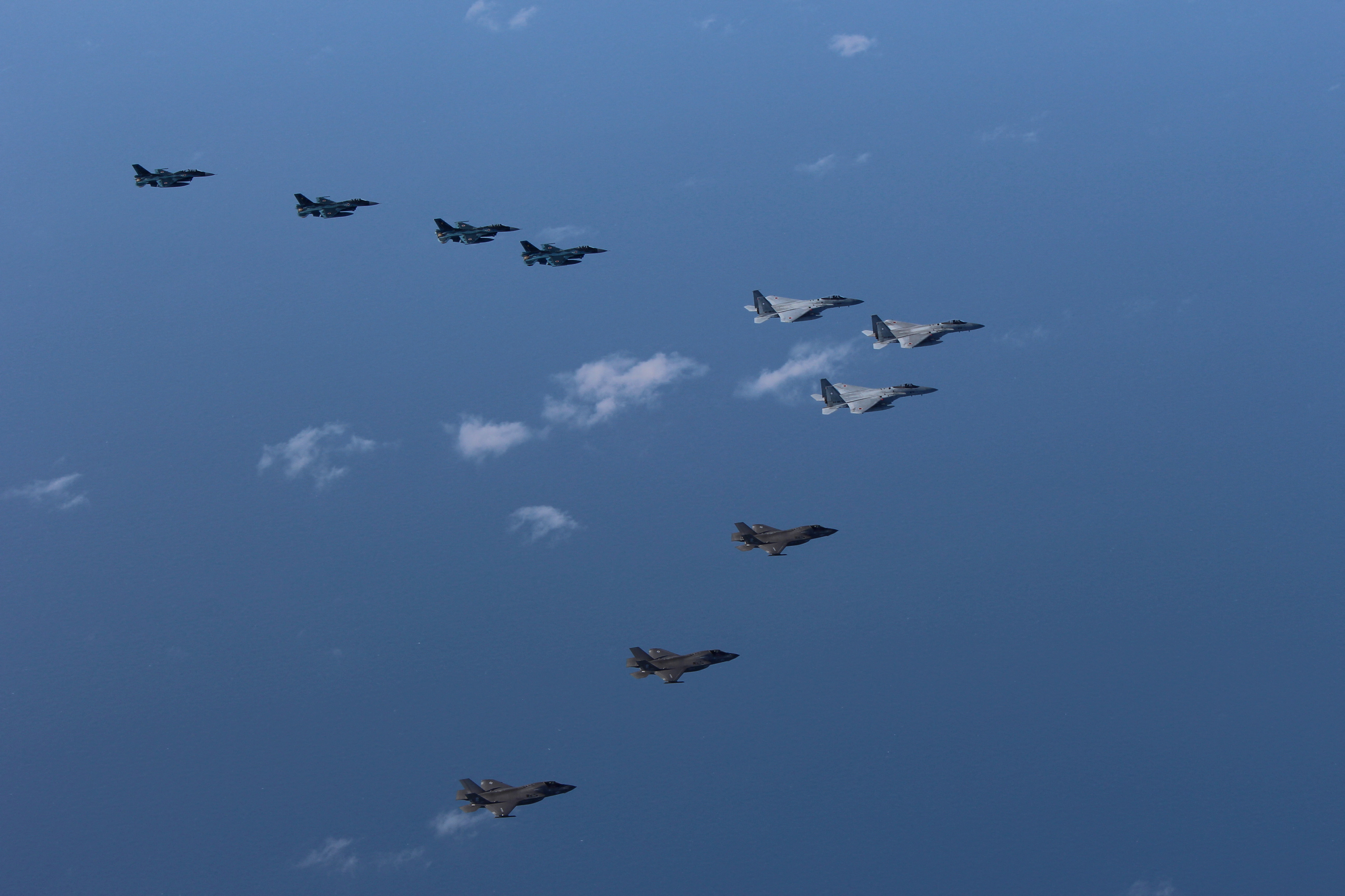 Japan Air Self-Defense Force's F-15 and F-2 fighters hold a joint military drill with U.S. Marine Aircraft Group's F-35B fighters off Japan's southernmost main island of Kyushu, Japan's F-15 and F-2 fighters hold a joint military drill with U.S. Marine Aircraft Group's F-35B fighters off Japan's southernmost main island of Kyushu, Japan