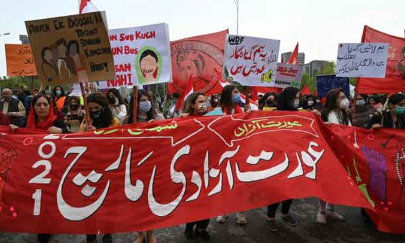 Activists of the Aurat March carry placards as they march during a rally to mark International Women's Day in Islamabad on March 8. — AFP/File