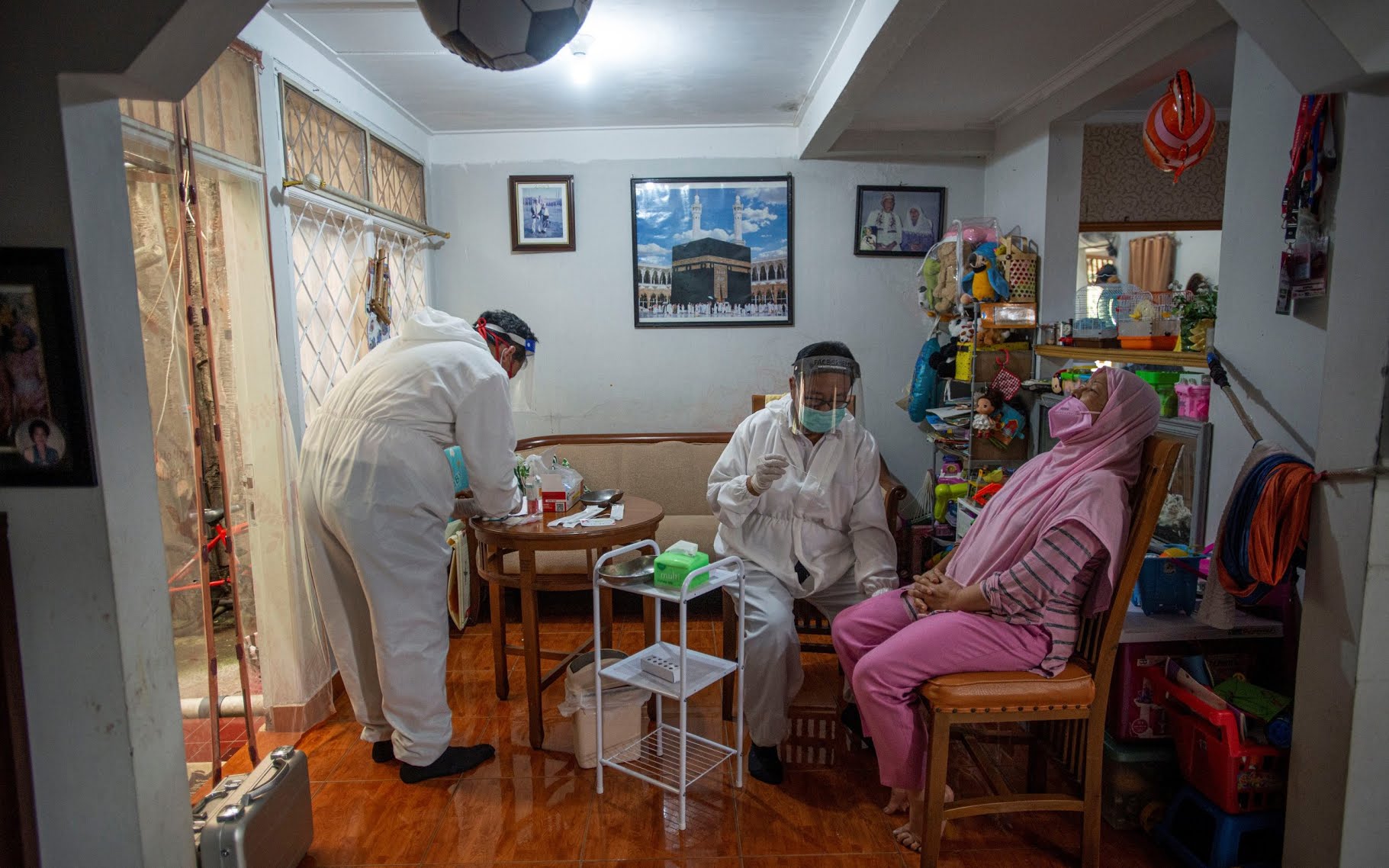 Healthcare workers prepare a swab sample at a testing centre in Bogor, on the outskirts of Jakarta