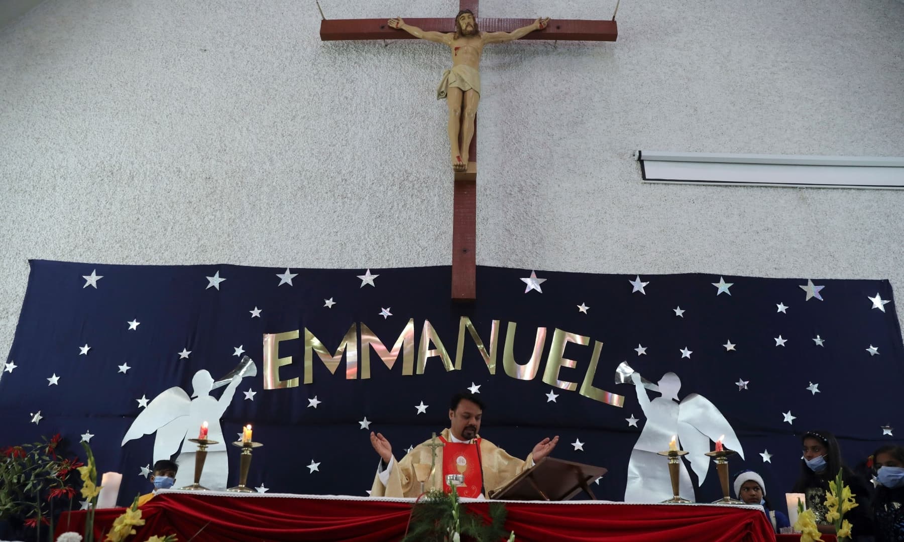 A priest leads a Christmas Mass at Our Lady of Fatima Church in Islamabad on December 25, 2021. — AP