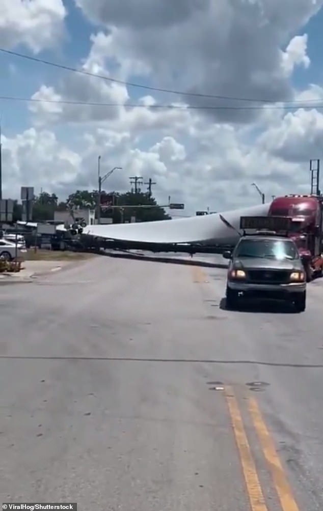 The railroad cross markers were seen collapsing on the back of the semi as the train began approaching