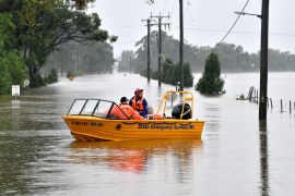 Members of State Emergency Service load medical supplies during a rescue operation at a flooded residential area in Windsor suburb of northwestern Sydney on March 23, 2021 [Saeed Khan/ AFP]