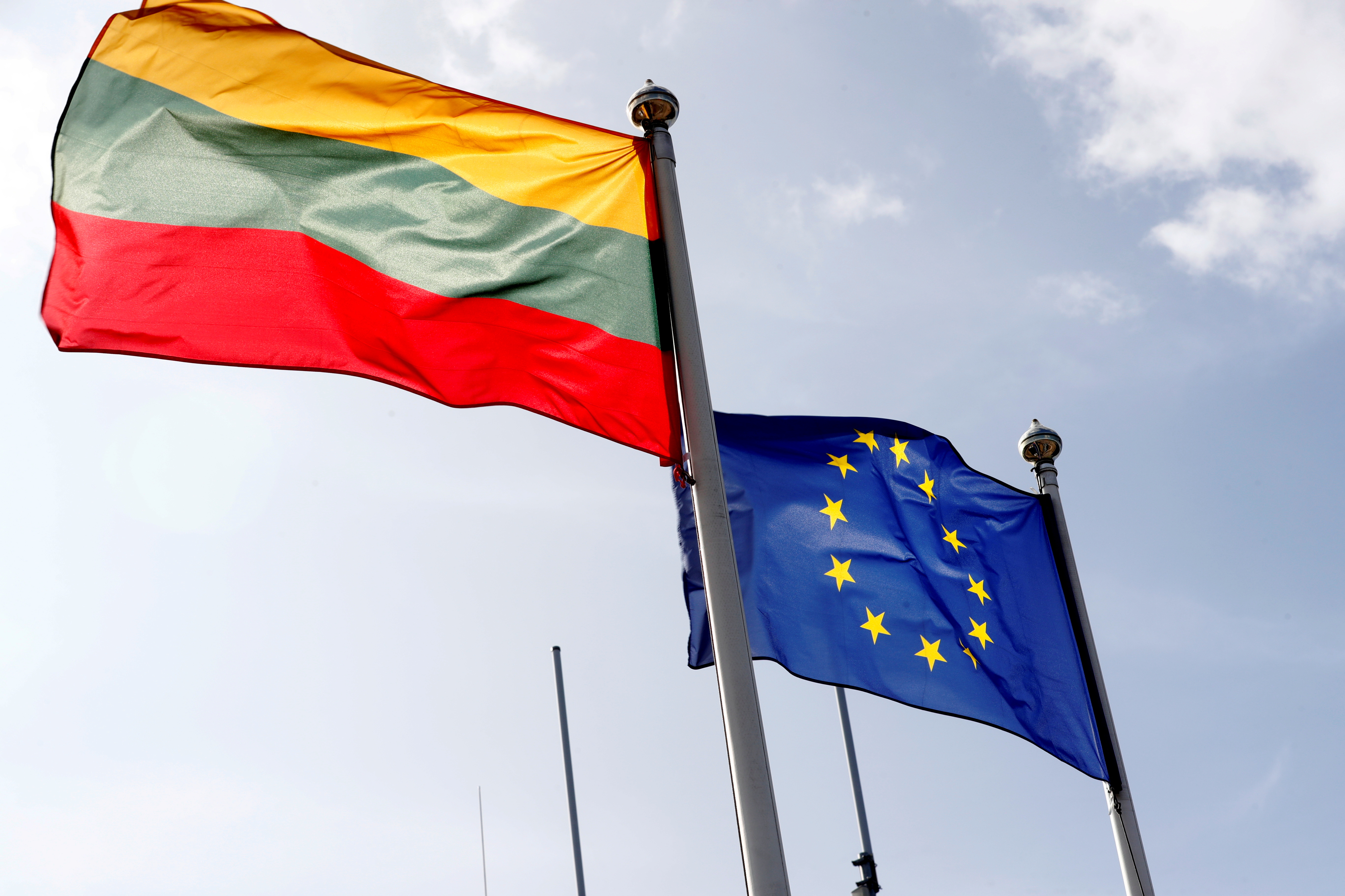 European Union and Lithuanian flags flutter at border crossing point in Medininkai, Lithuania September 18, 2020. REUTERS/Ints Kalnins/File Photo