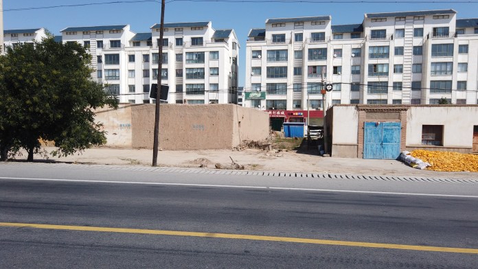 The old, adobe buildings in front have been replaced by modern apartments behind