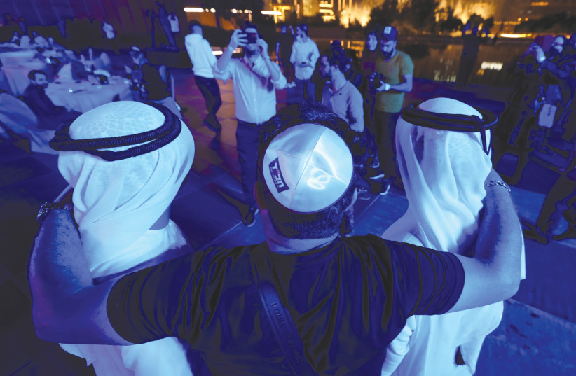 ISRAELIS AND locals celebrate Hanukkah in Dubai, on December 10. (photo credit: CHRISTOPHER PIKE/REUTERS)