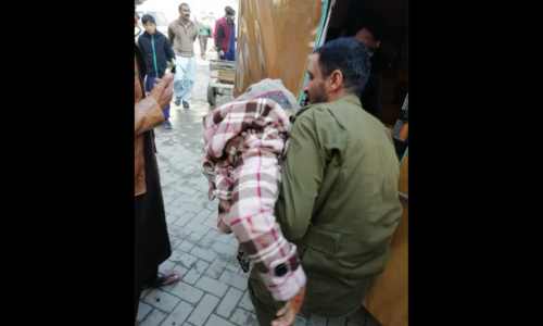 An injured person is being taken to a hospital by a resident after an explosion at Rawalpindi's Ganj Mandi police station. — DawnNewsTV