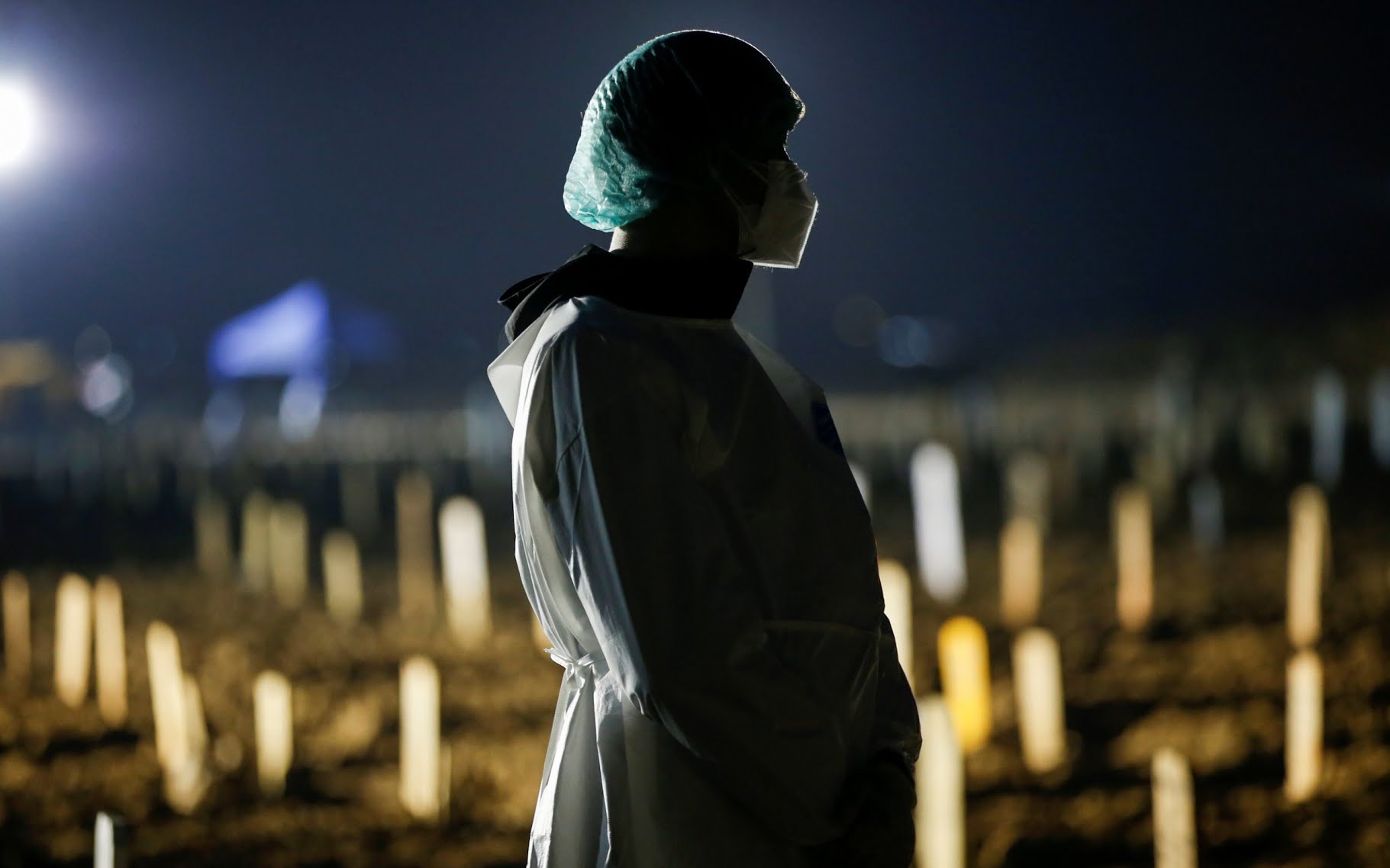 Toni Tanama, 31,  at the funeral of his 51-year-old mother at a burial area for Covid-19 victims, in Jakarta