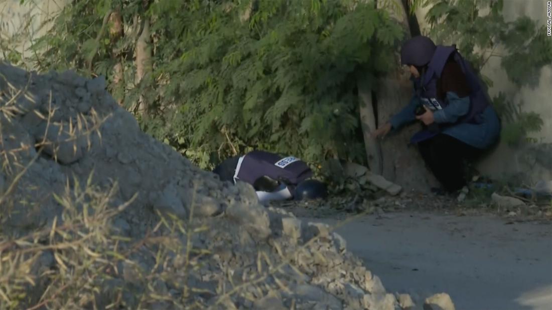 Shireen Abu Akleh lies face down in the street, after having been shot in the head.