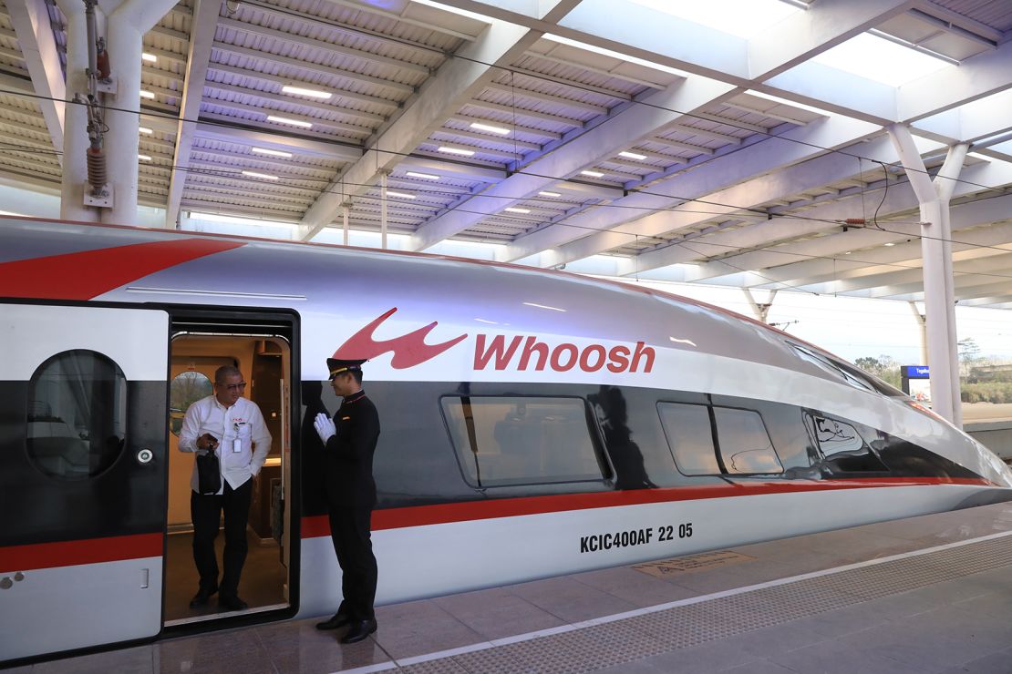 A passenger gets off a Jakarta-Bandung high-speed train at Tegalluar station during the start of its commercial operation on October 17, 2023 in Bandung, West Java, Indonesia.