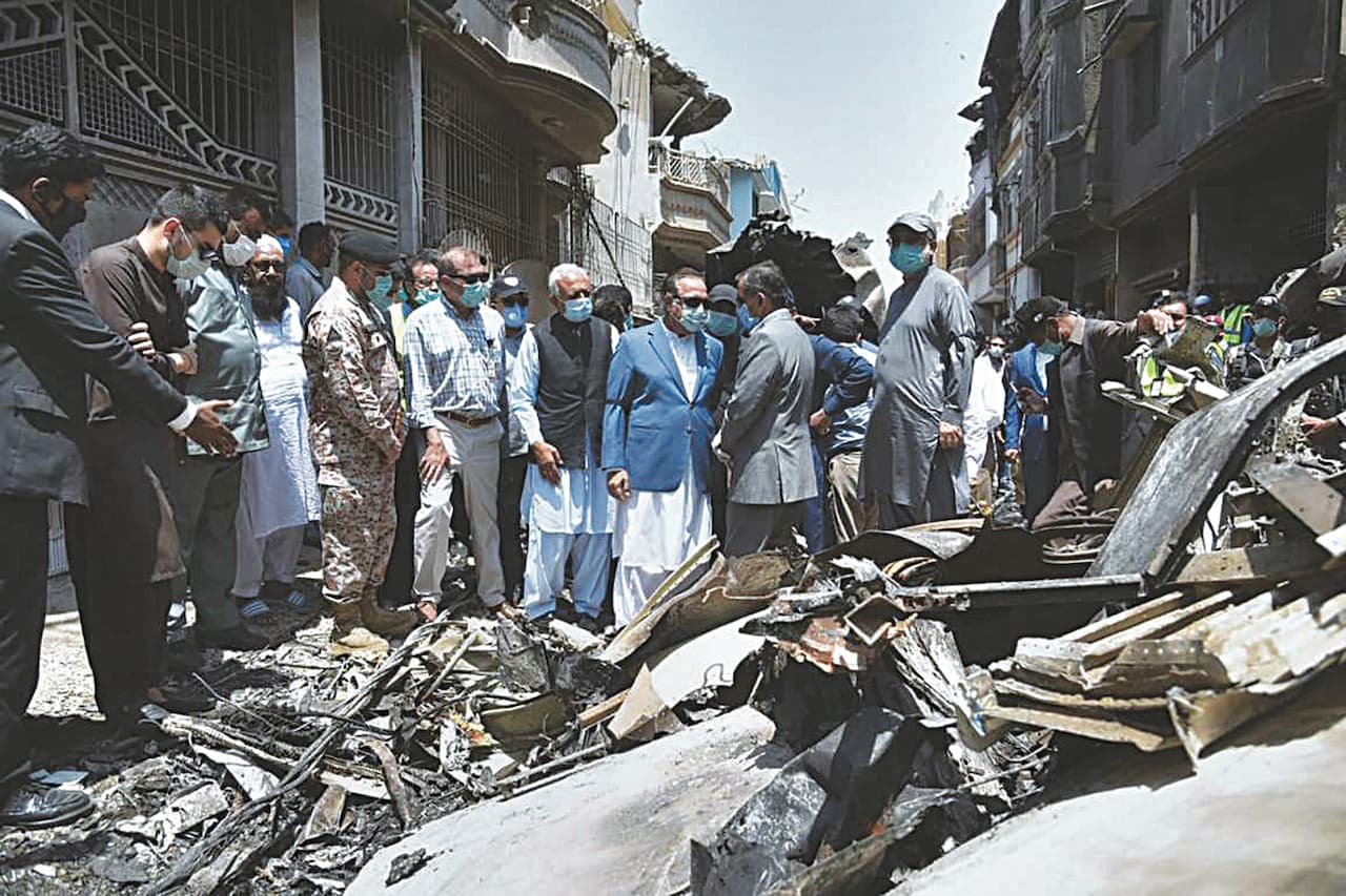 Governor Imran Ismail and Aviation Minister Ghulam Sarwar visit the site of the May 22 PIA plane crash in Karachi | AFP