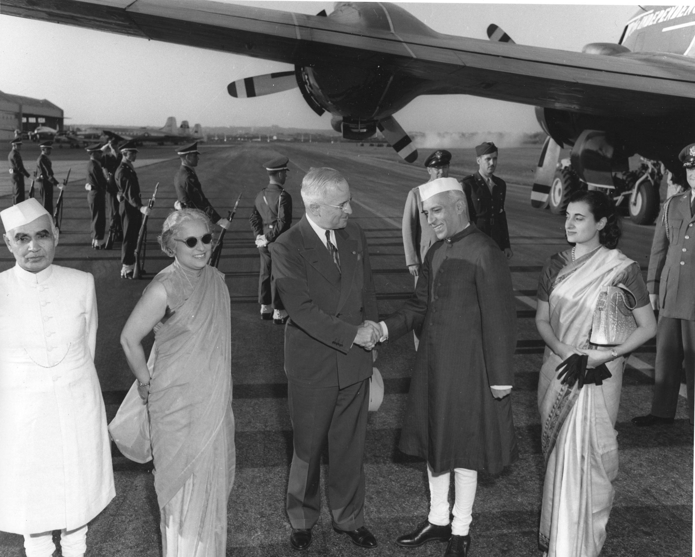 American President Harry S. Truman shakes hands with Indian Prime Minister Jawaharlal Nehru on the tarmac as Nehru’s sister, diplomat Vijaya Pandit, and daughter, future Indian Prime Minister Indira Gandhi, stand with them, in Washington D.C., on October 11, 1949. (PhotoQuest/Getty Images))