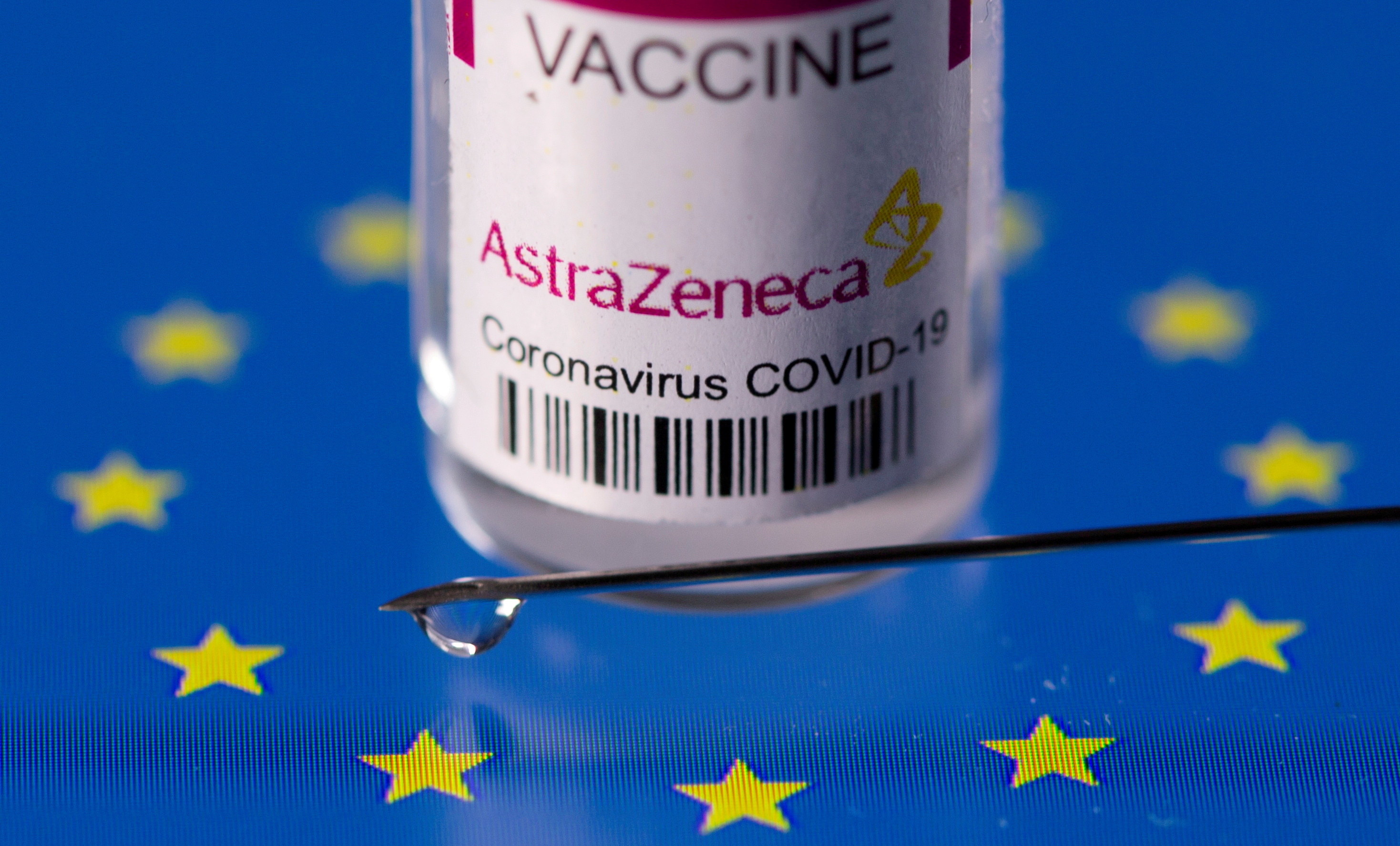 Vial labelled AstraZeneca coronavirus disease (COVID-19) vaccine placed on displayed EU flag is seen in this illustration picture taken March 24, 2021. REUTERS/Dado Ruvic/Illustration