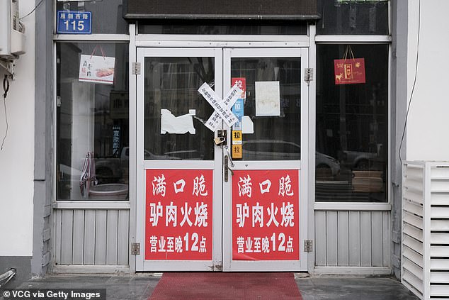 Officers reportedly arrived at shops and restaurants and told owners they had to close their businesses for seven days. Pictured: A closed restaurant in Anxin County, Xiongan New Area