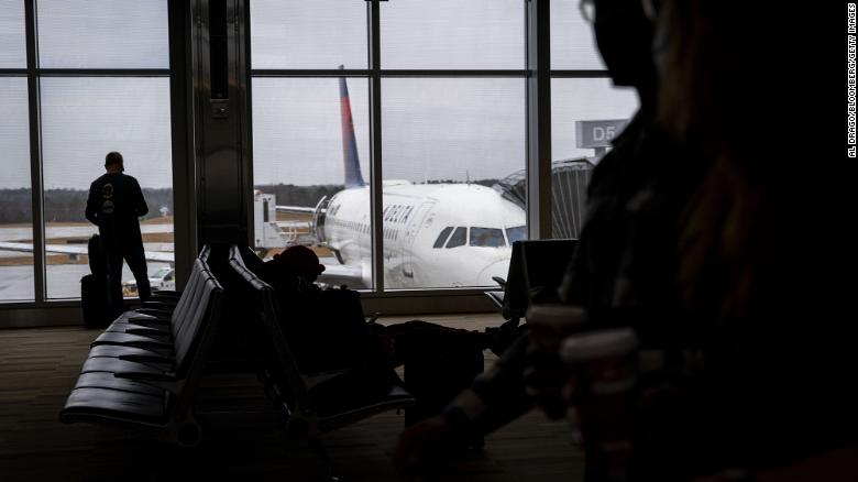 Travelers walk through terminal 2 at Raleigh-Durham International Airport (RDU) in Morrisville, North Carolina, U.S., on Thursday, Jan. 20, 2022.