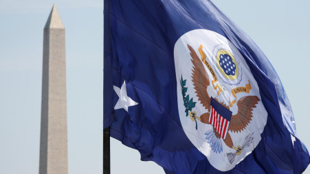 With the Washington Monument behind, the State Department flag flies over its grounds in Washington, US, May 8, 2018. REUTERS/Kevin Lamarque