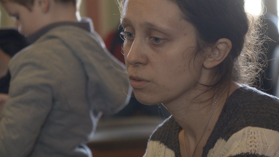 Woman in waiting room at station