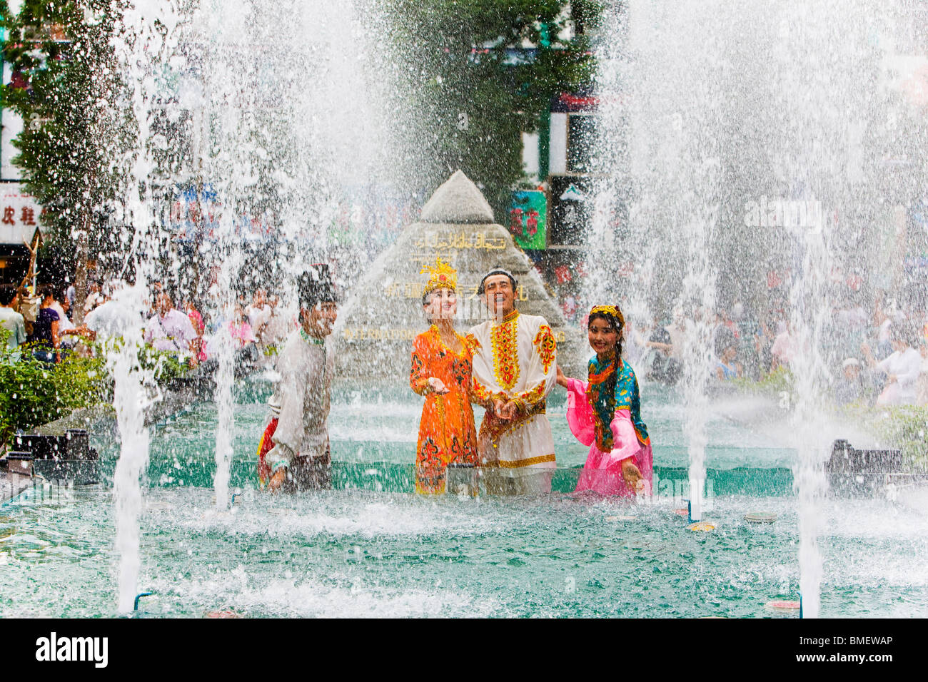 uygur-people-in-traditional-costume-standing-in-fountain-international-BMEWAP.jpg