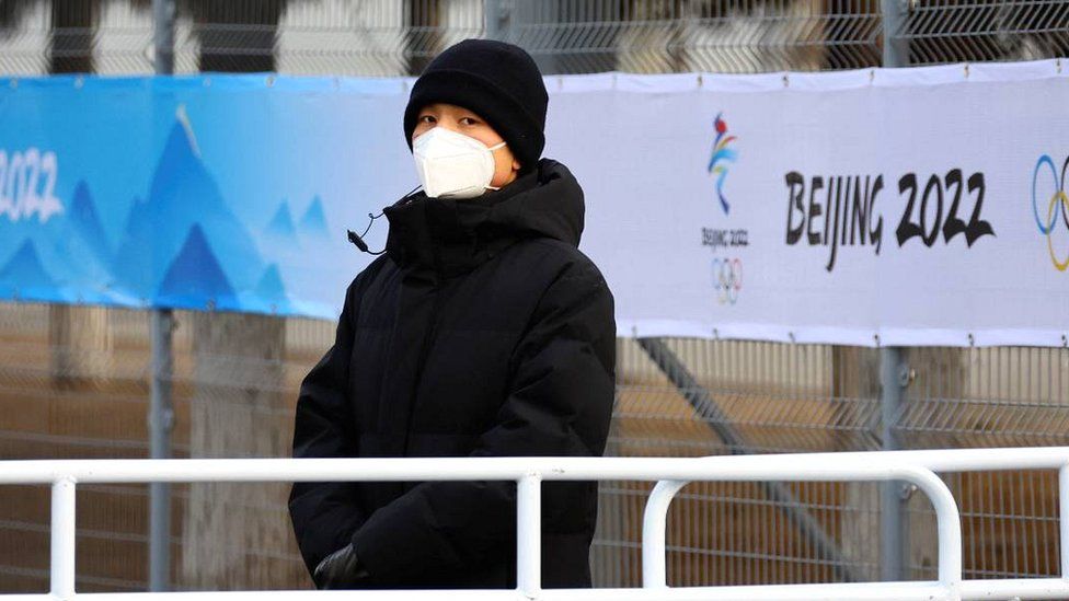 A security person stands guard outside the main press centre inside a closed loop area in Beijing